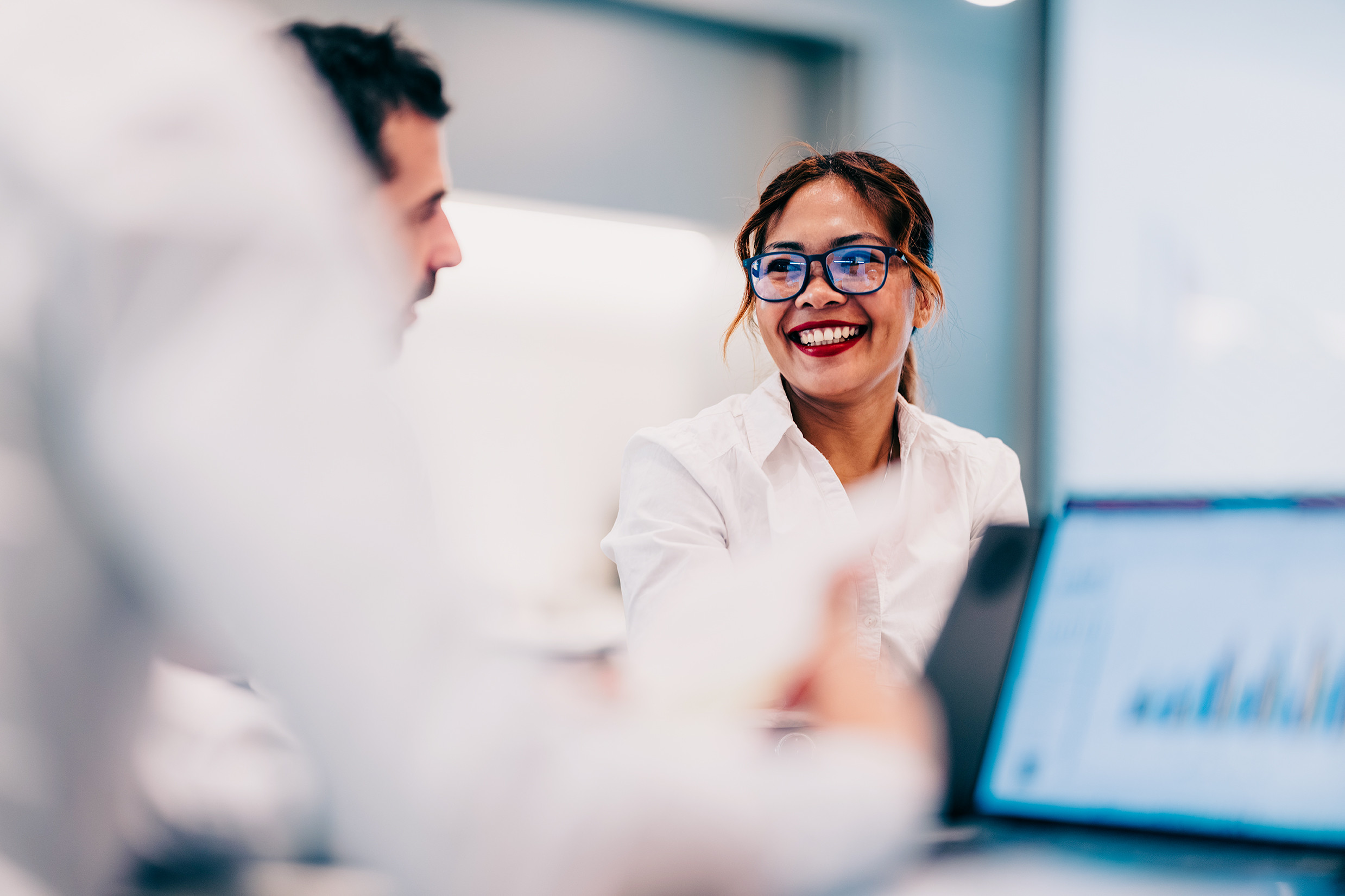 Person smiling at a workstation