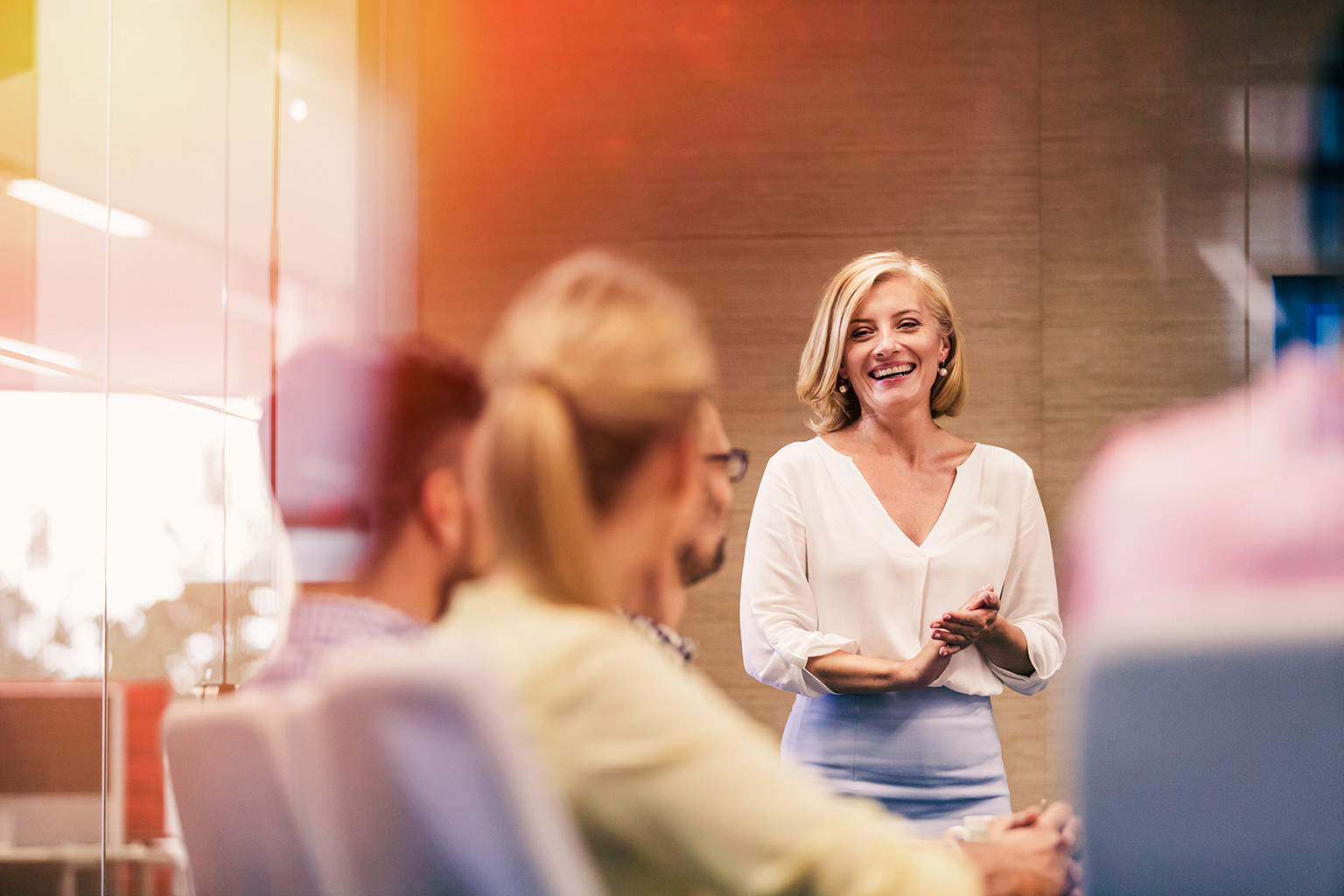 Smiling businesswoman leading meeting in conference room