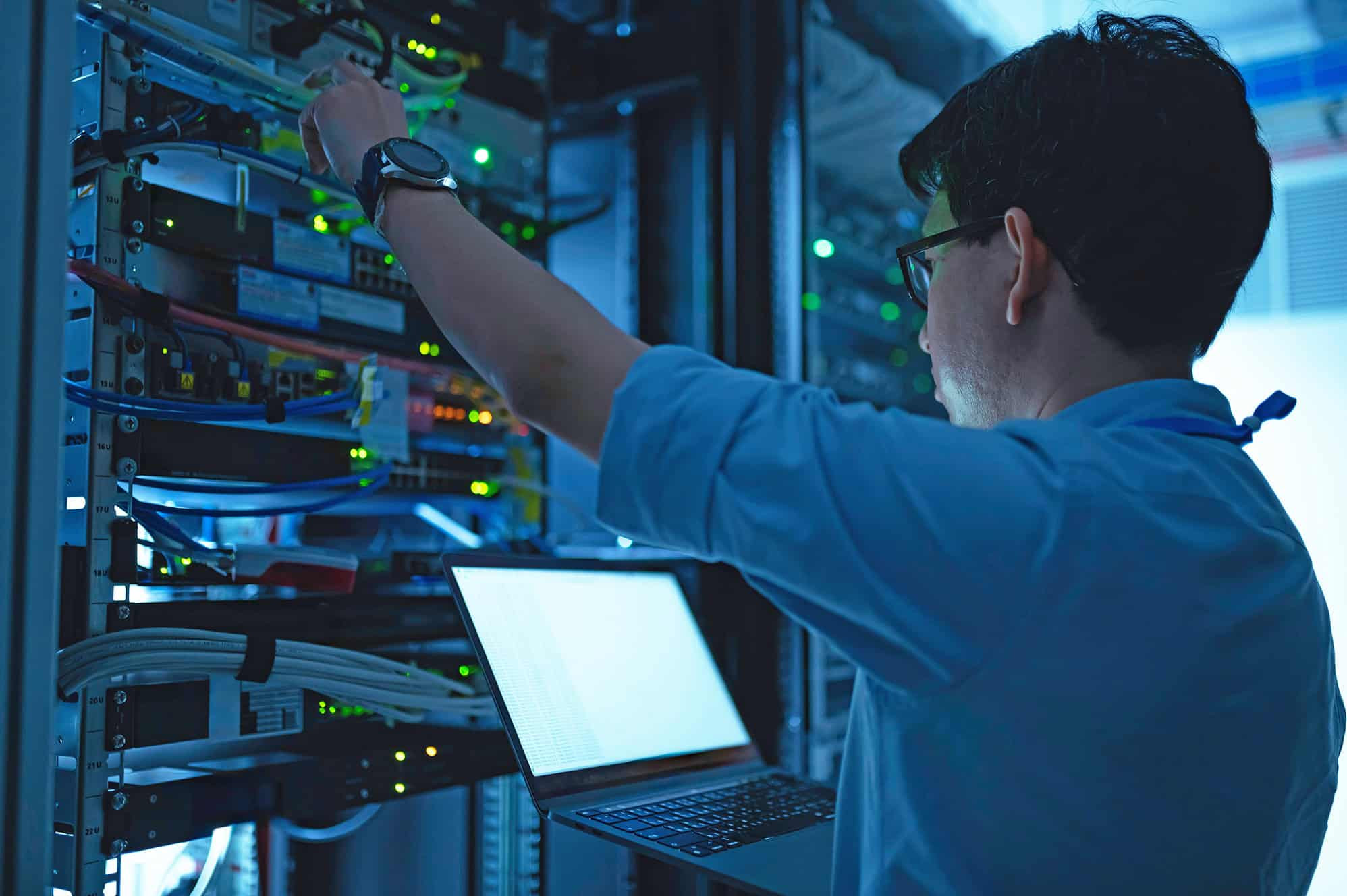 IT professional maintaining server equipment in a data center