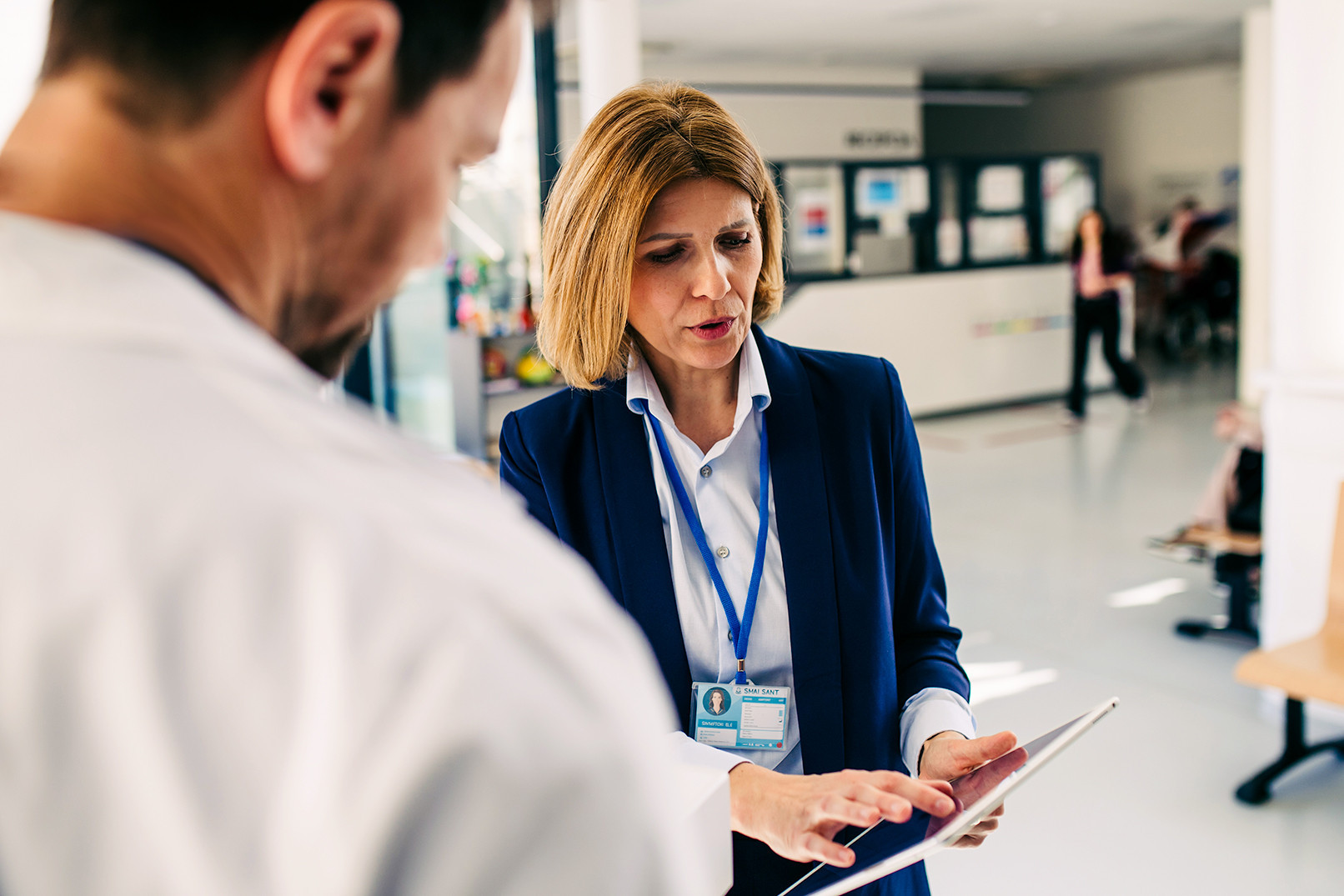 Female medical sales representative presenting medication to doctor