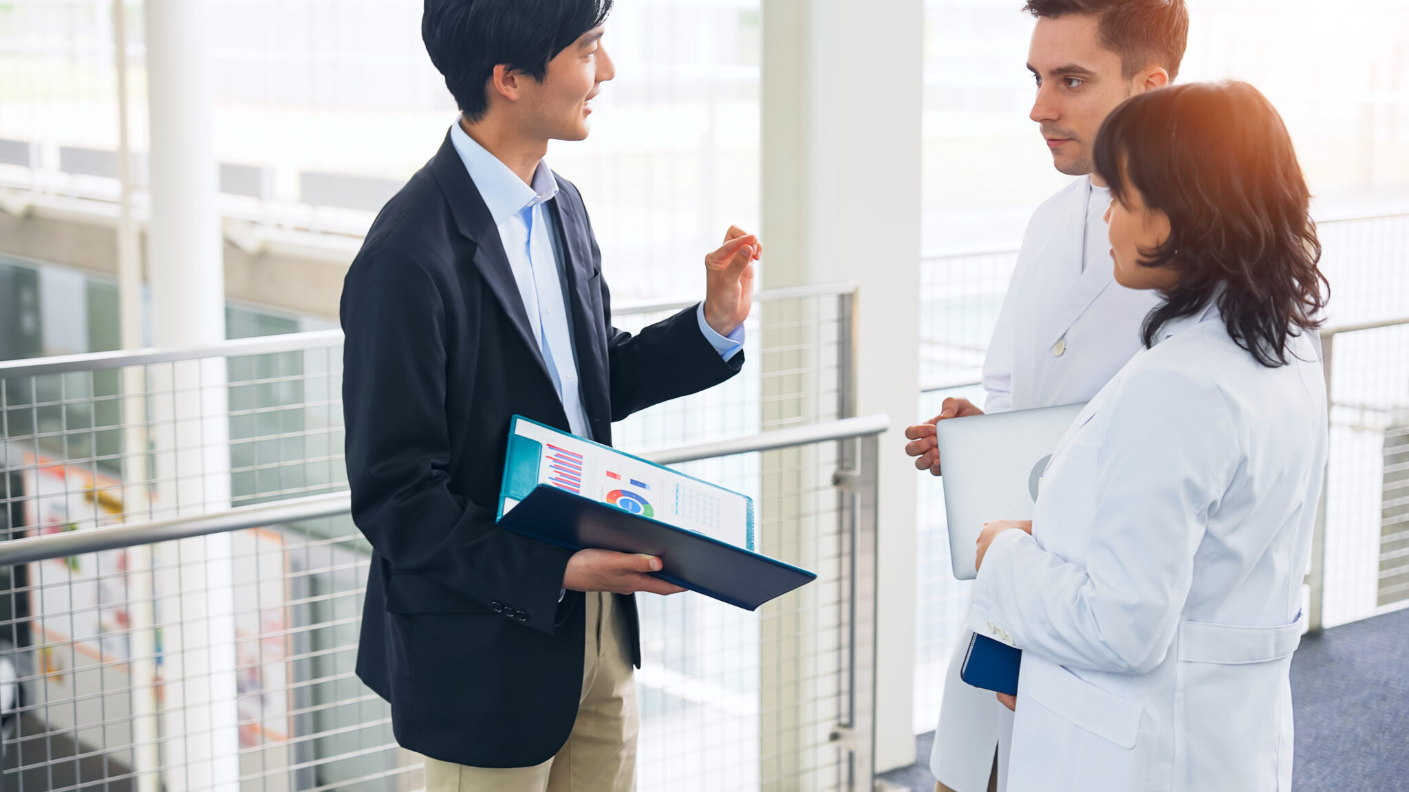 Administrative and clinical team members reviewing reports together in a medical facility