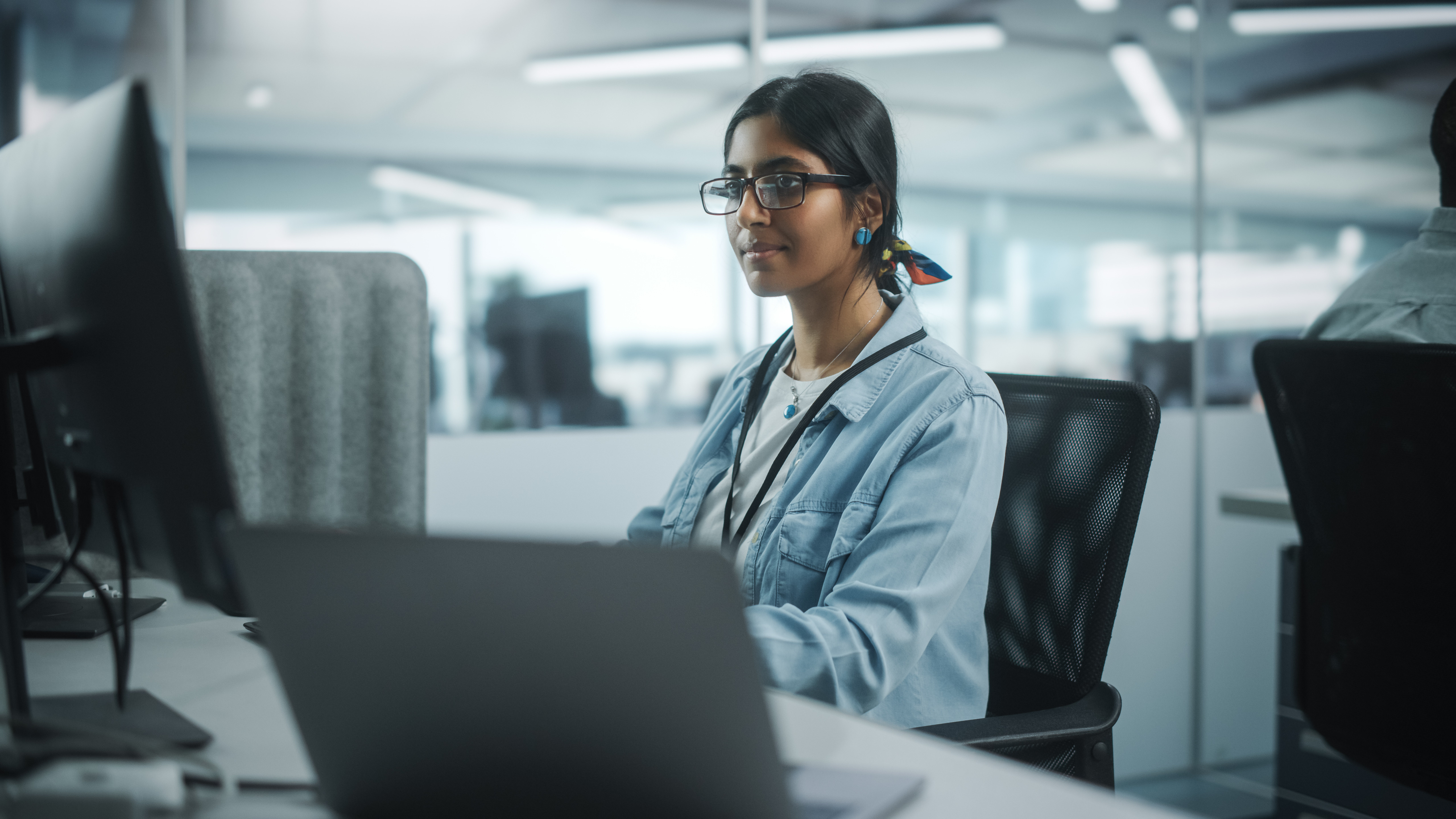 Healthcare technology professional working on healthcare innovation solutions at a computer workstation.