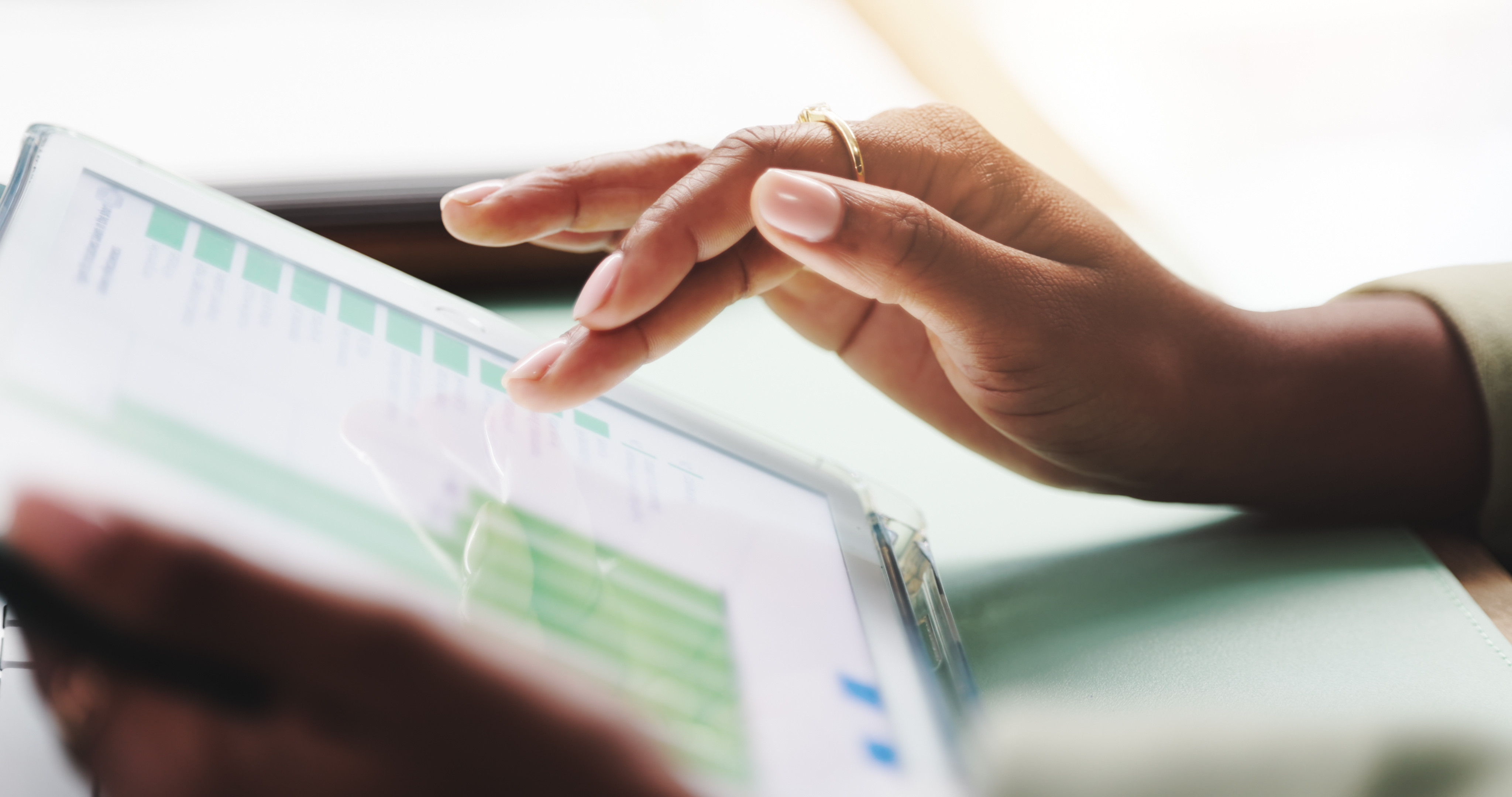 Healthcare professional reviewing data analytics on a tablet to improve healthcare operations and revenue performance.