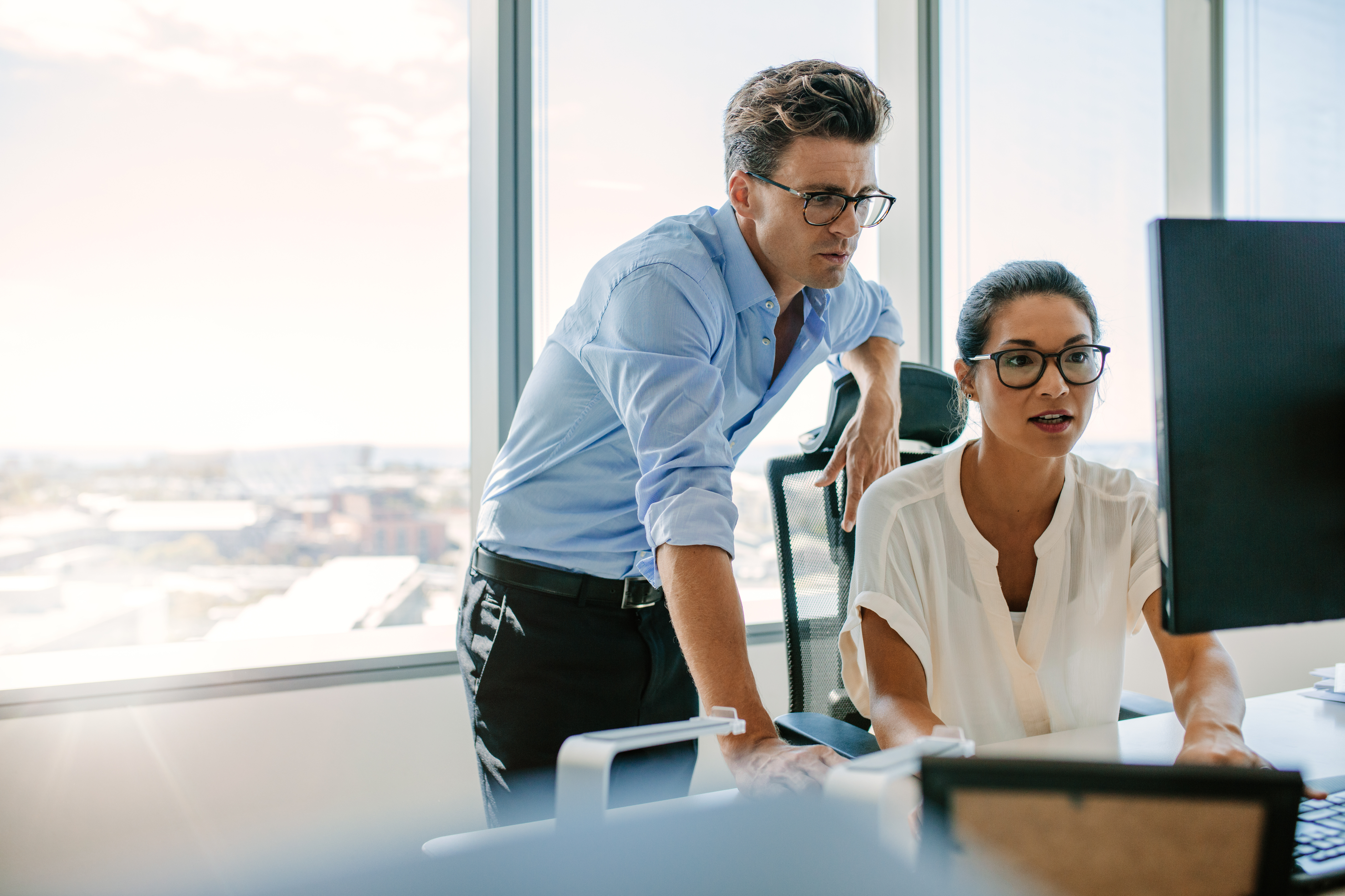 Two corporate professionals working together on computer