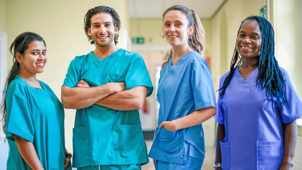 Healthcare team members standing together in a hospital corridor, representing collaboration, patient care, and operational excellence