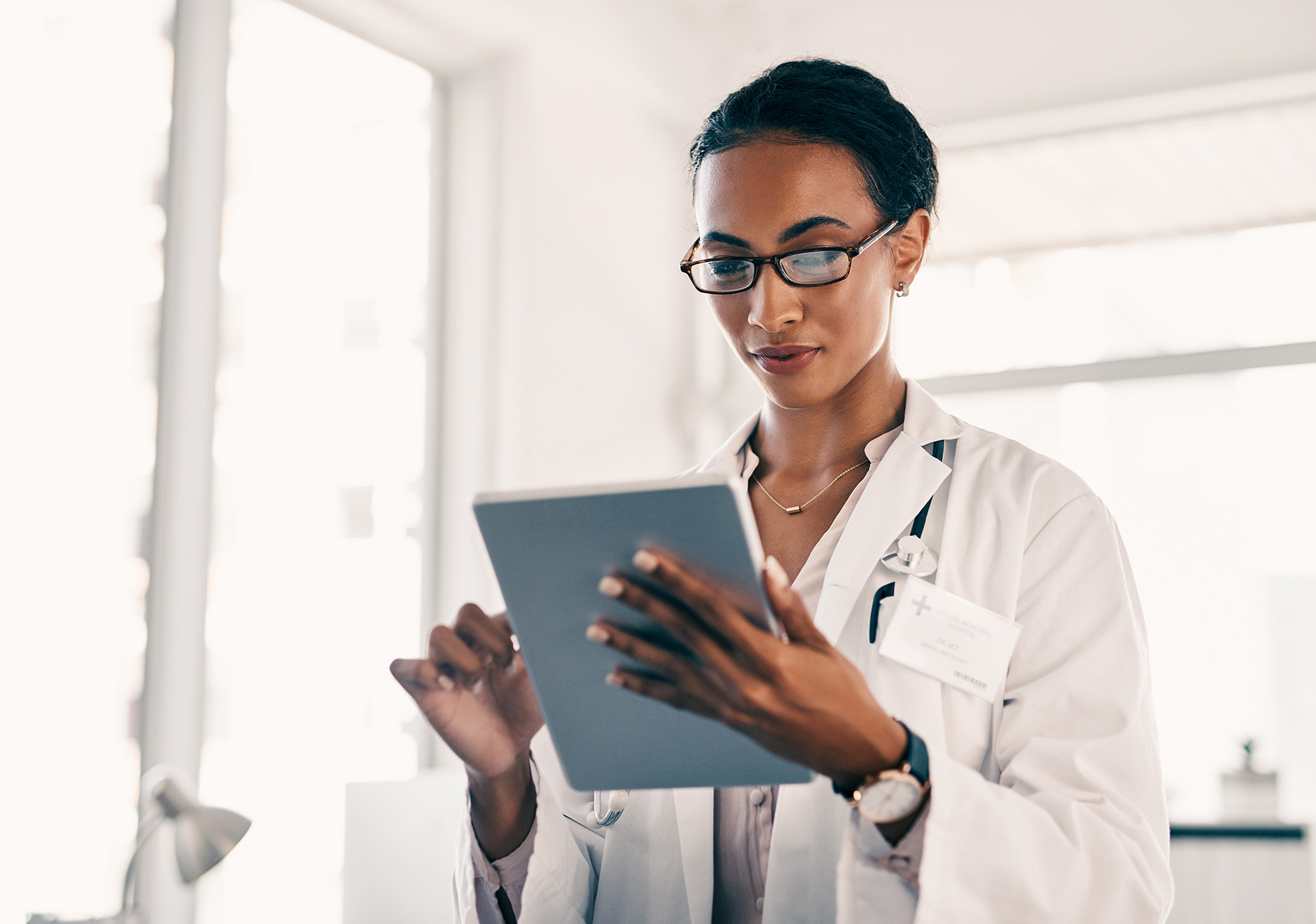 Digital tablet, research and women doctor at hospital for planning, schedule and management. Healthcare, app and female physician online for internet, search and results while reading medical news