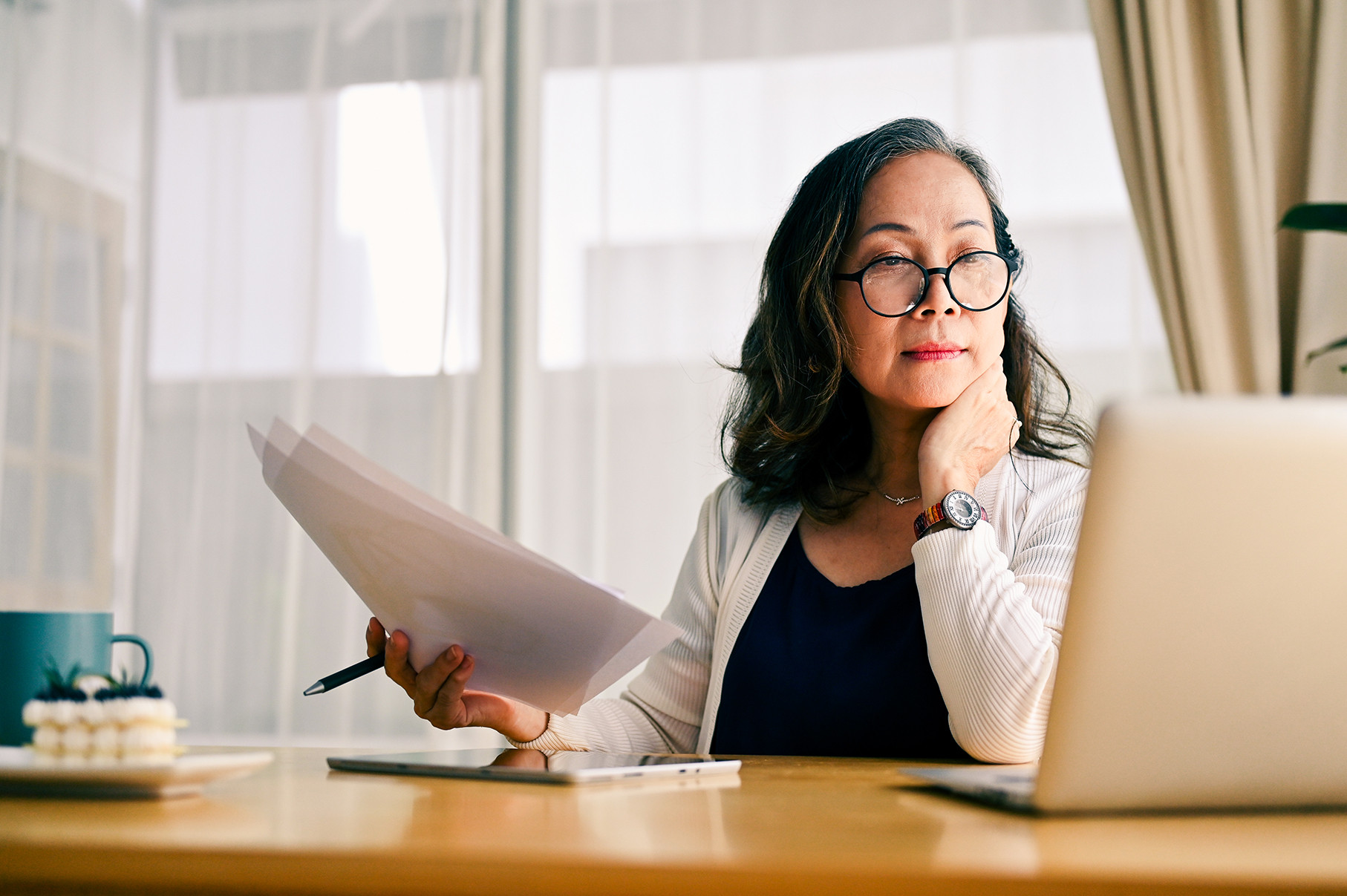 Concentrated asian middle aged female businesswoman using portable computer