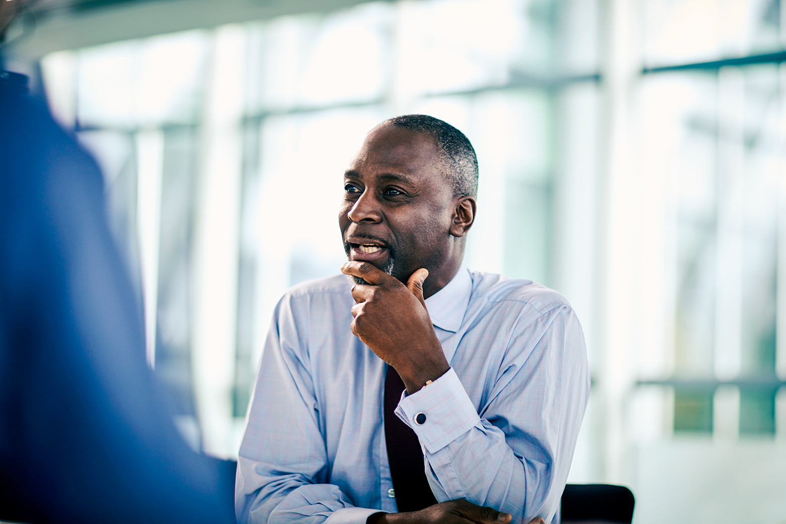 Businessman listening looking away in meeting