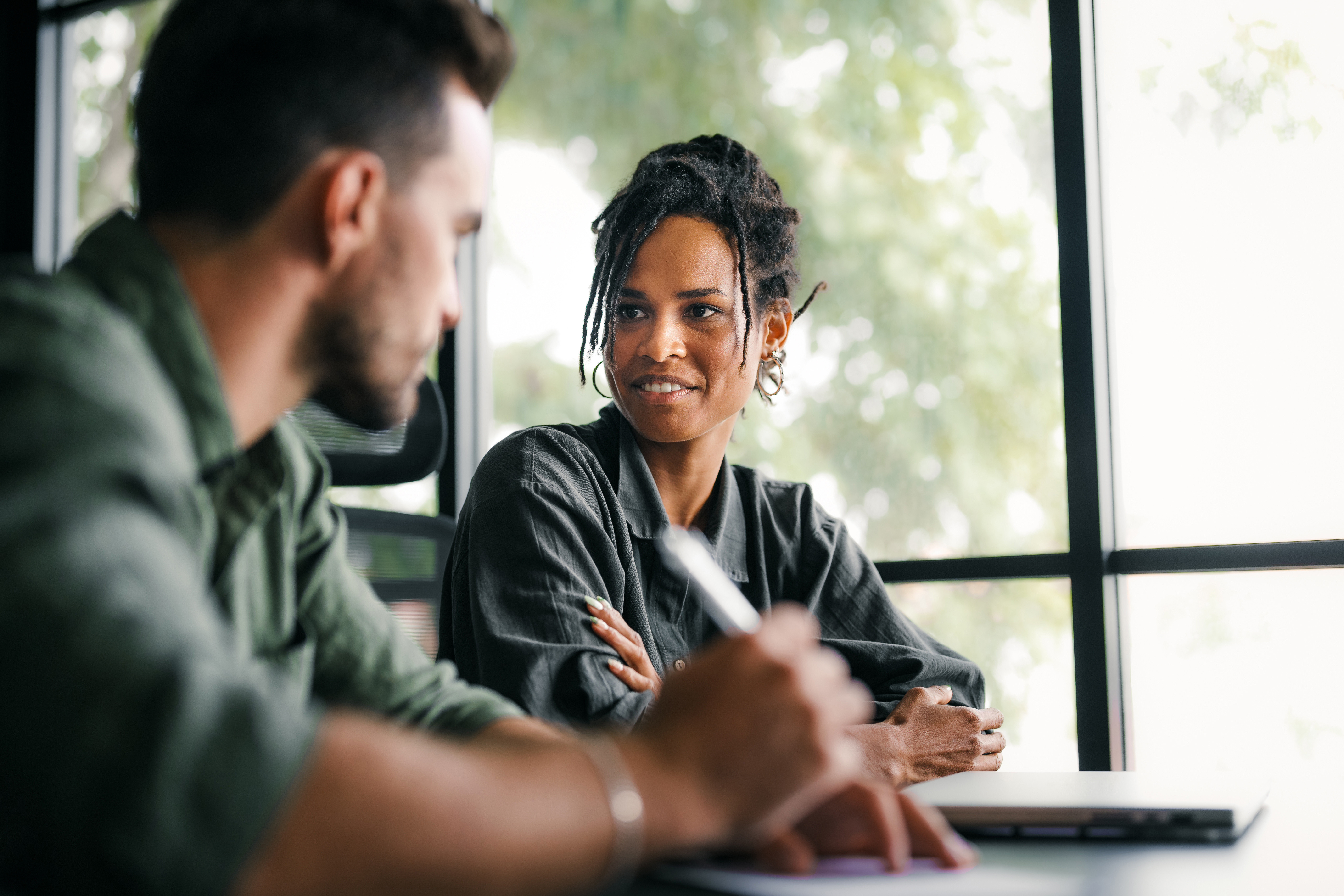 Group of young multi-ethnic startup business team collaborating on project in modern office