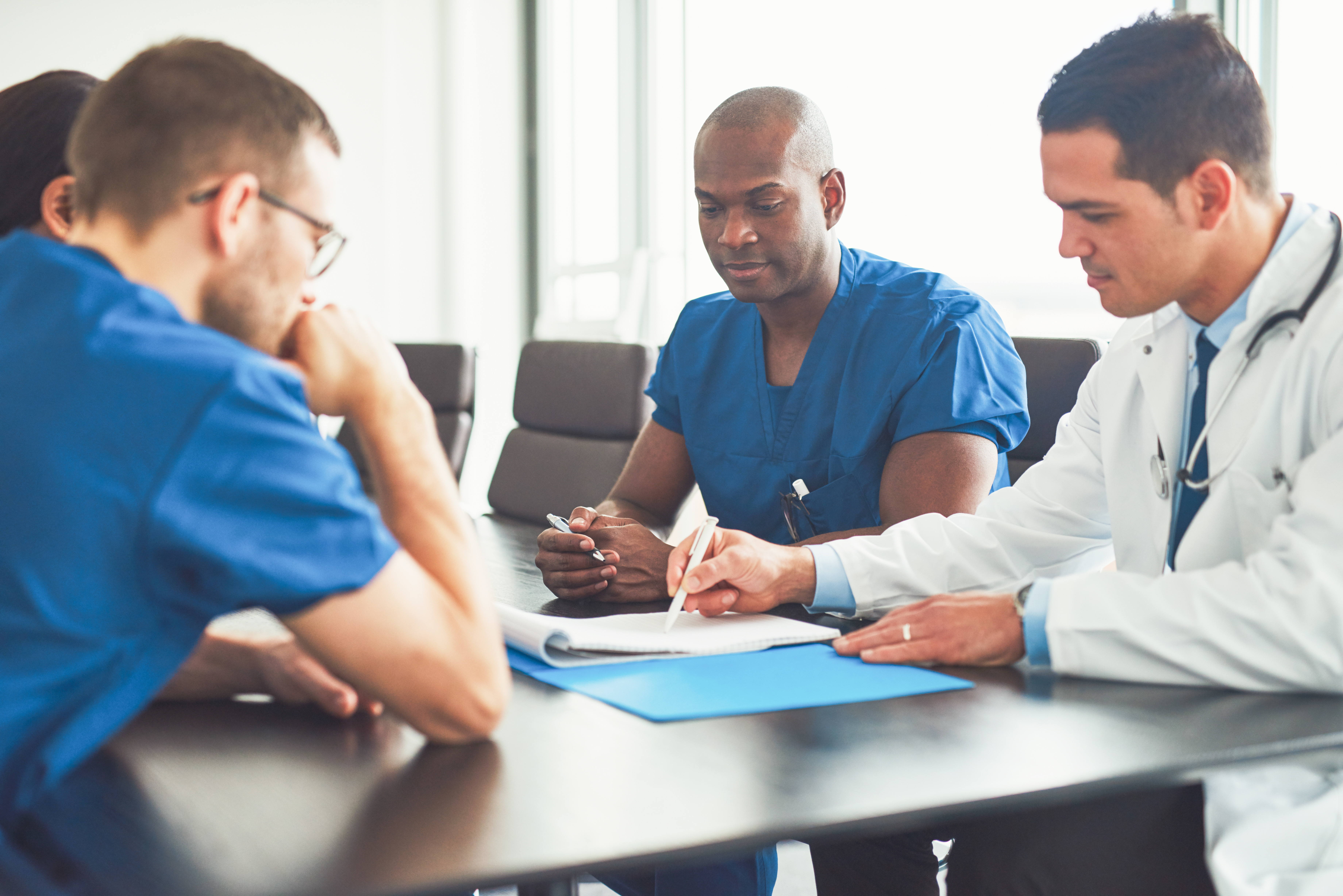 Healthcare professionals collaborating on patient care and clinical decision-making to improve outcomes and operational performance.