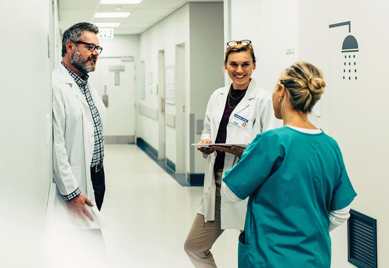 Healthcare staff coordinating care and operational improvements within a modern healthcare facility.