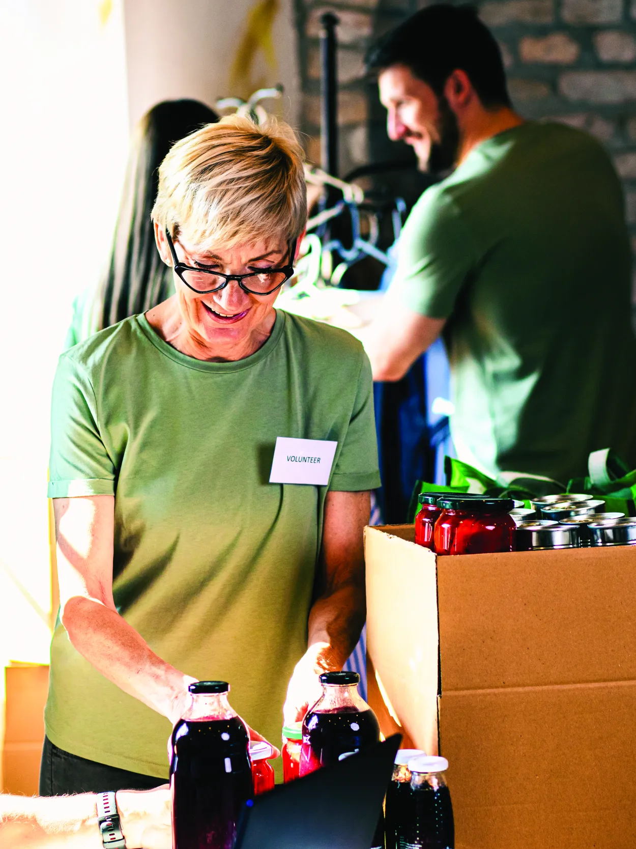 Employees participating in a community volunteer event, organizing donated goods and supporting local outreach initiatives
