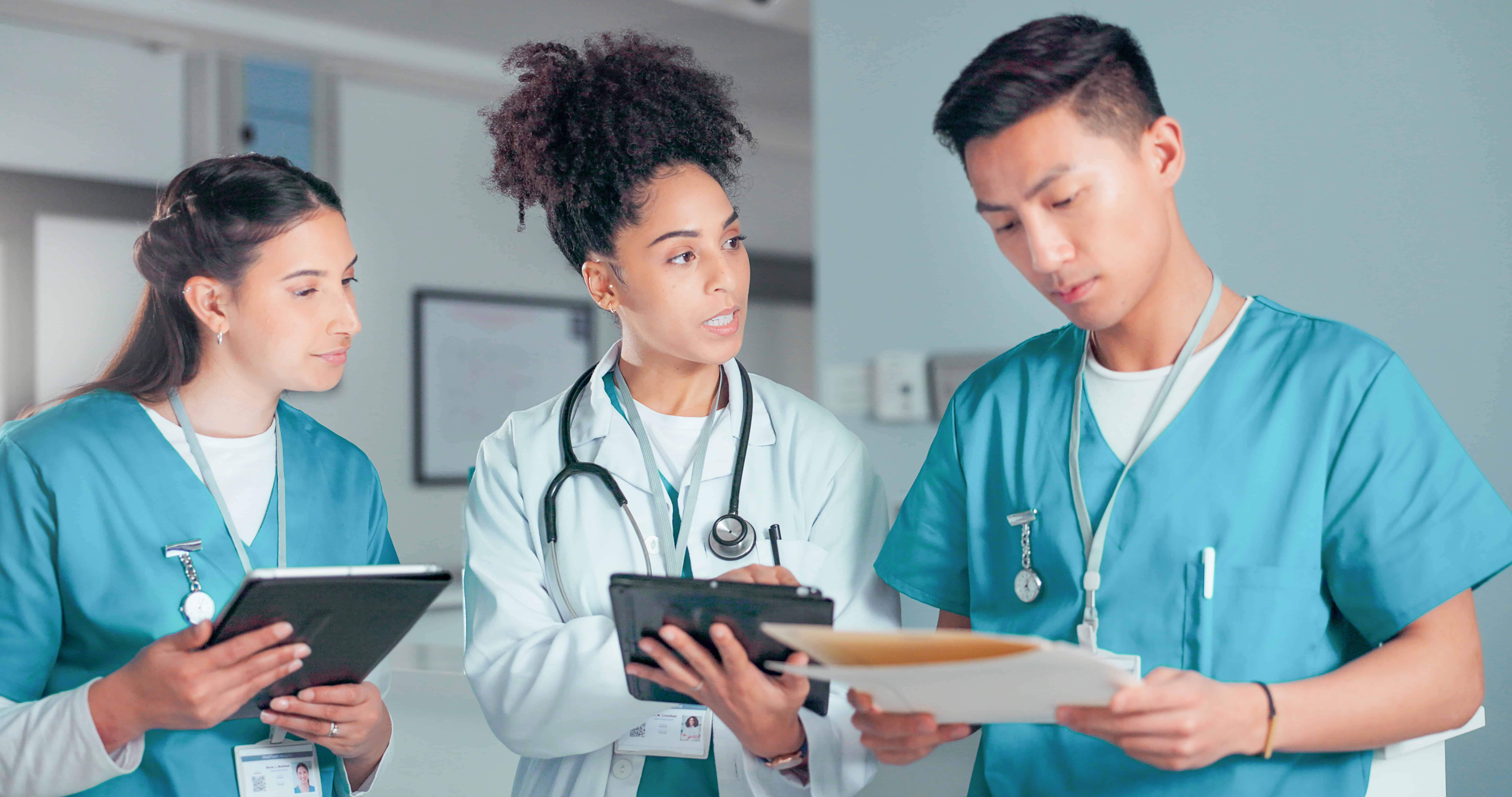 Clinical team reviewing patient documentation together in a hospital setting