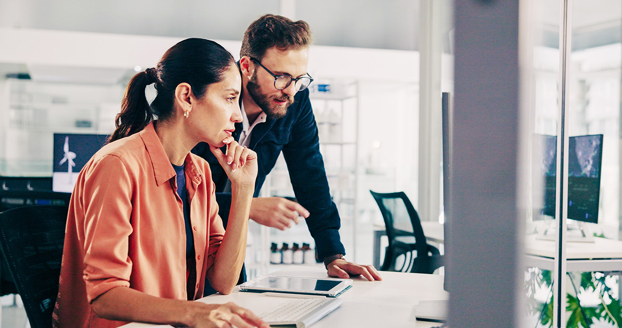 Team collaborating at a computer to analyze data and improve operational efficiency and revenue performance.