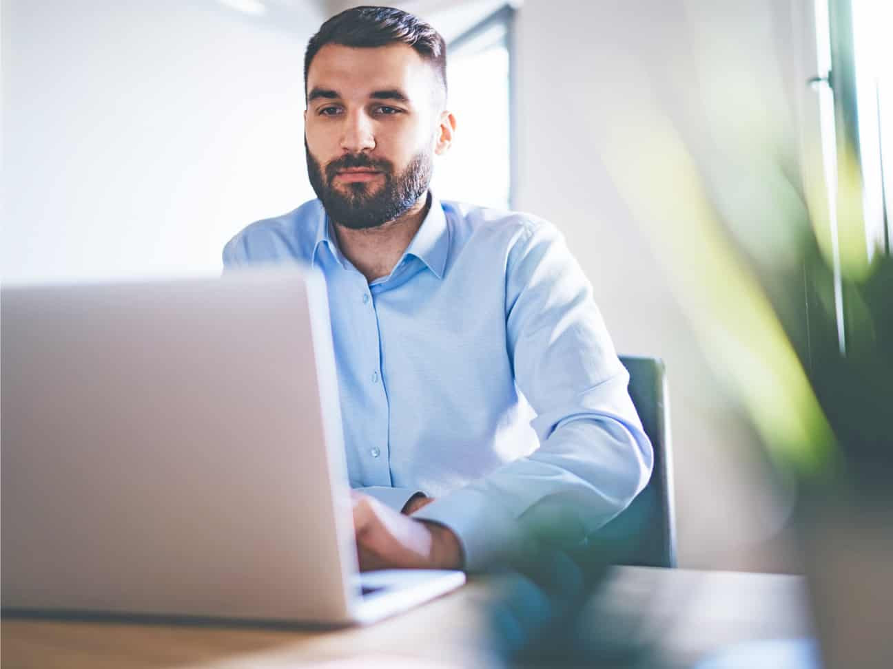Professional working on a laptop to support healthcare revenue cycle management, operational efficiency, and business performance