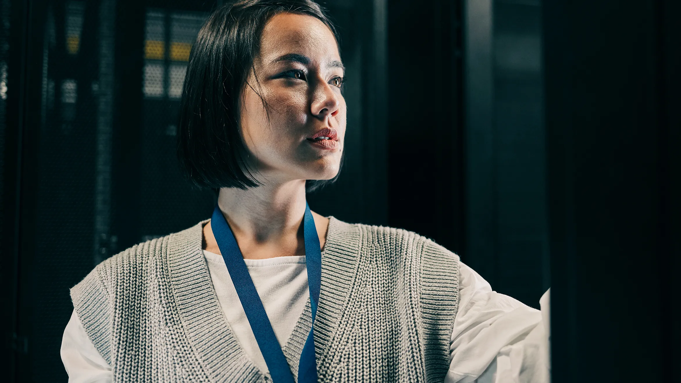Serious, maintenance or IT woman in server room for analysis, engineer working in data center. Thinking, cybersecurity and girl programmer with tech for problem solving, diagnose or troubleshooting