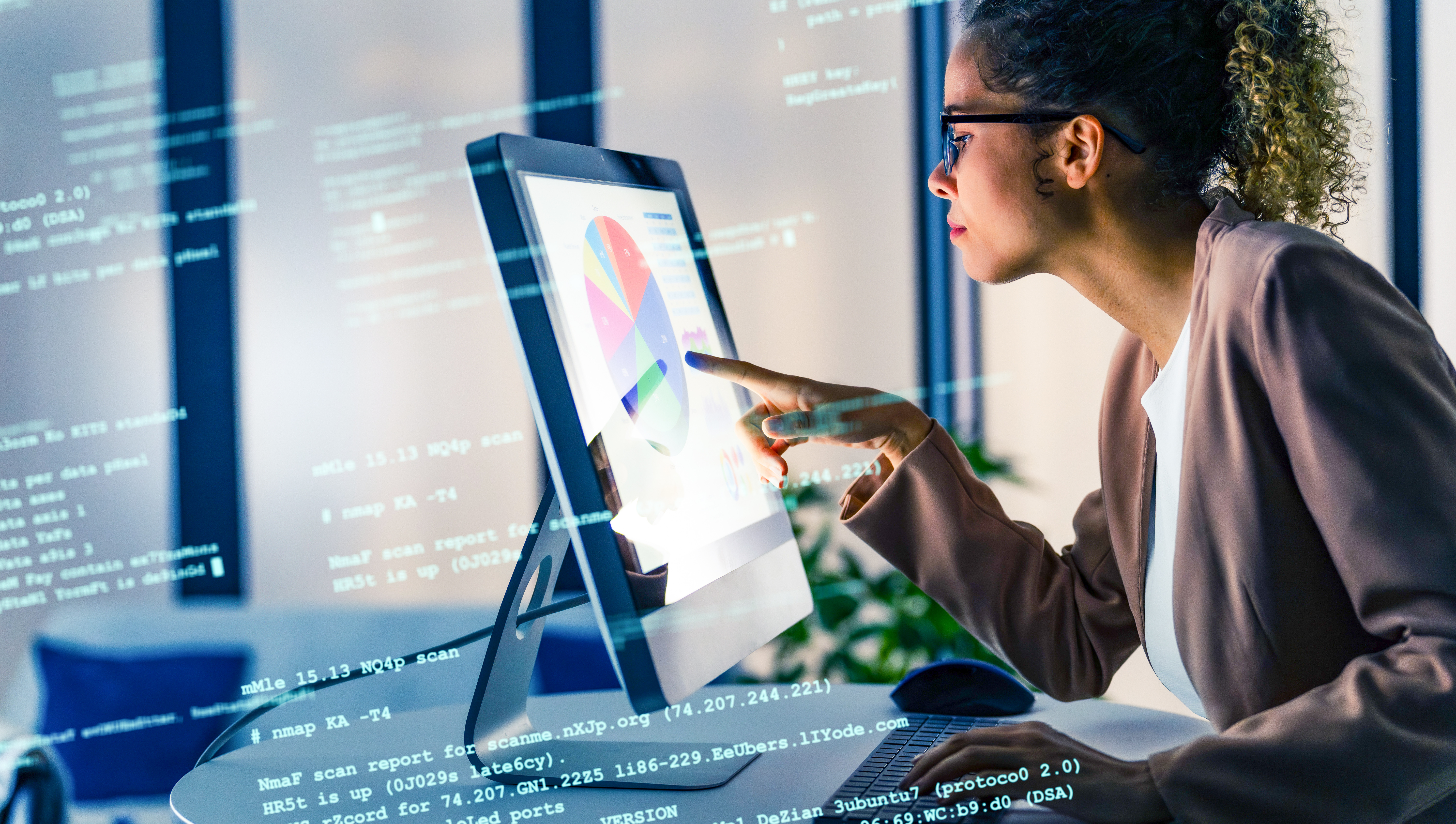 Professional analyzing data on a computer dashboard with charts and code overlays, representing data analytics and digital transformation.