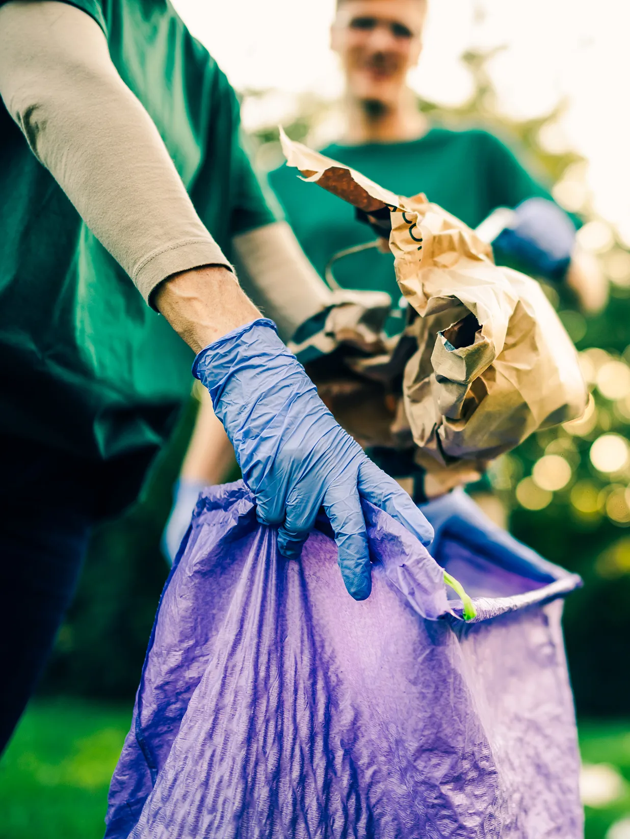 Group of volunteers collecting garbage in park