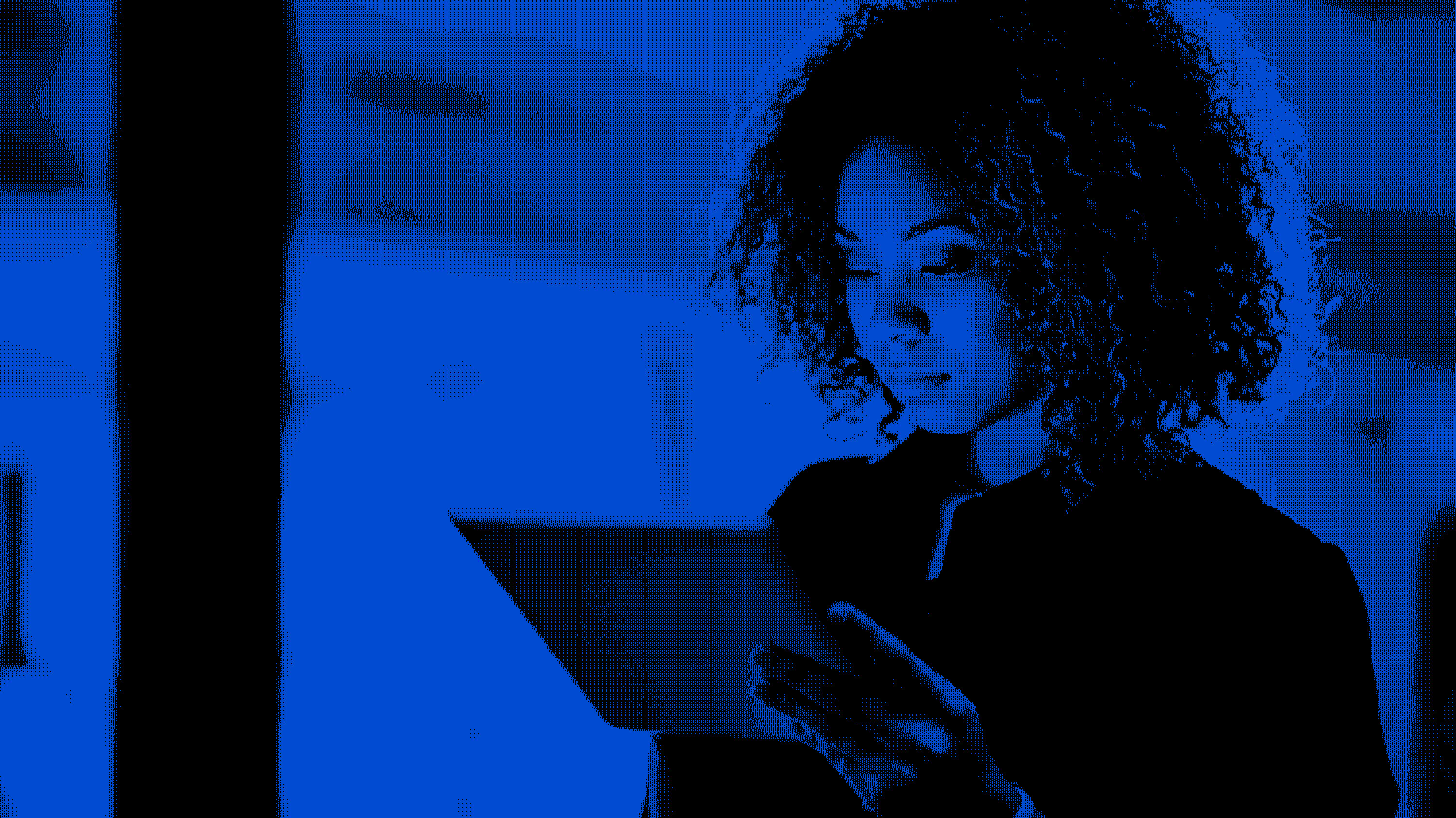 Healthcare technology professional reviewing healthcare data and technology systems on a tablet.