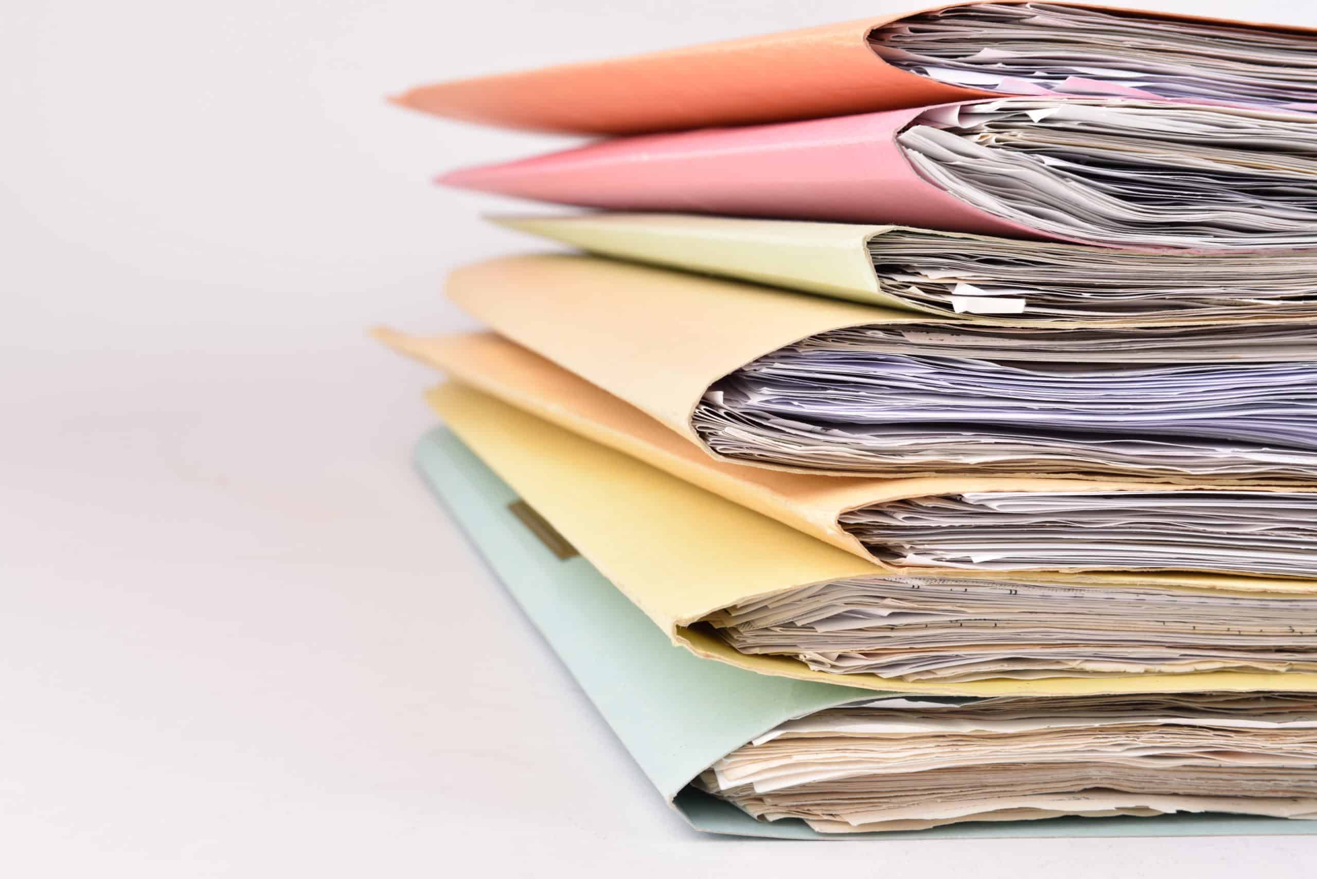 colorful paperwork Stacked files on isolated background