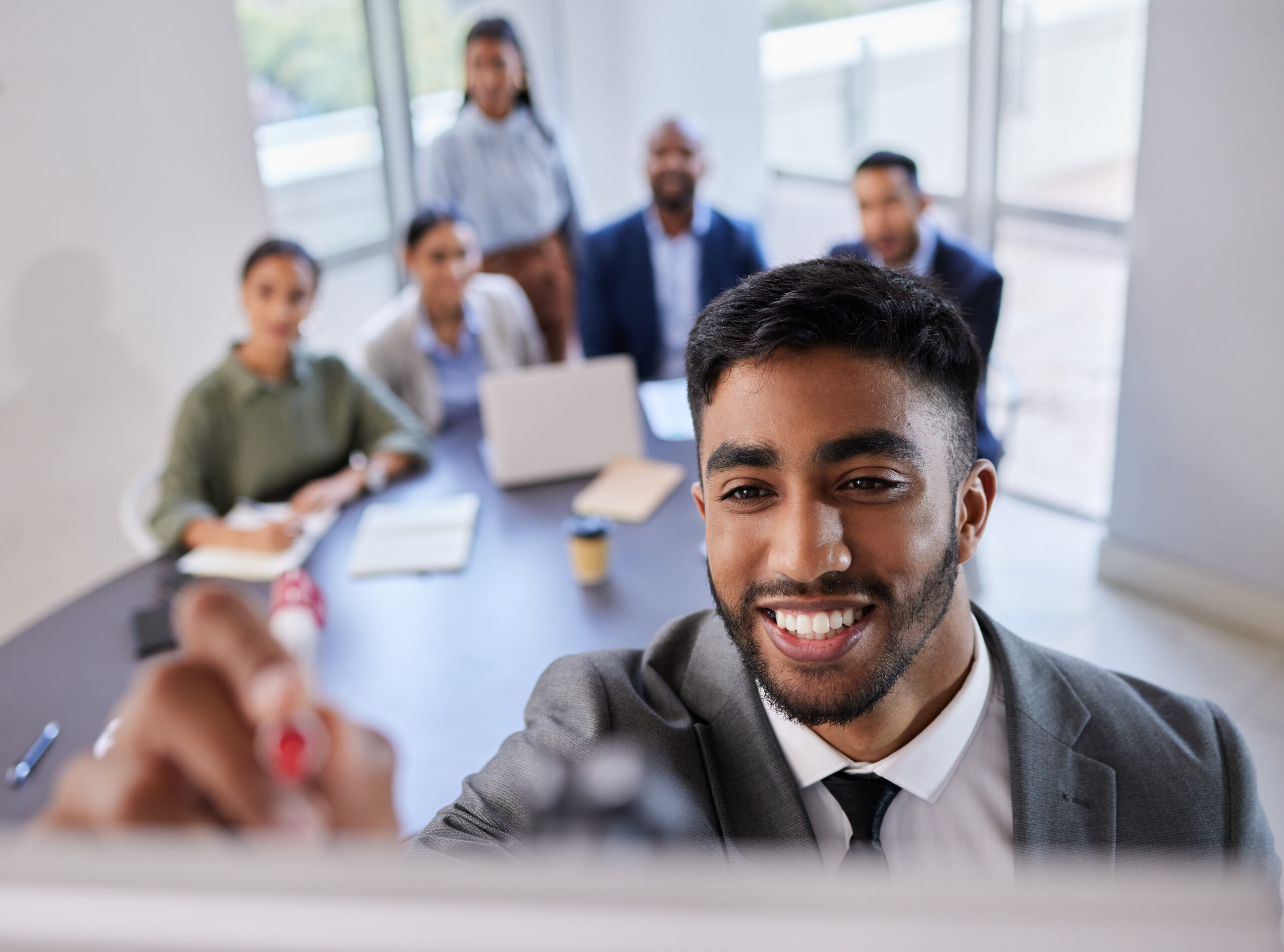 Business, happy man and writing at whiteboard for presentation, meeting and planning collaboration. Seminar, brainstorming and face of male manager at board for training team in corporate workshop