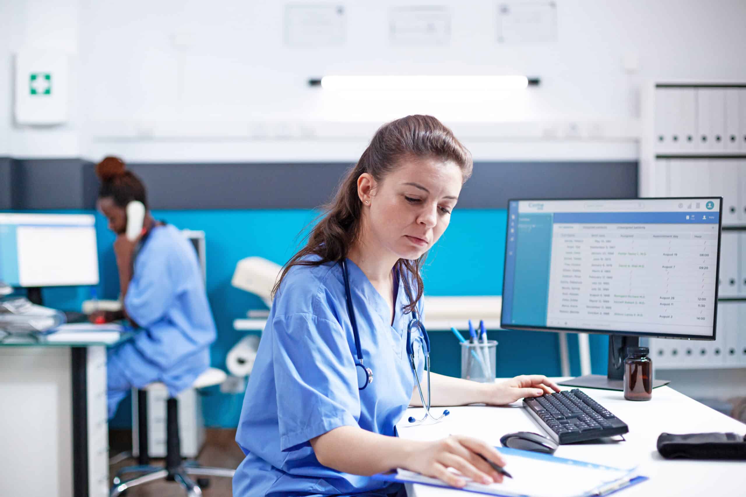 Caucasian nurse checking data in office