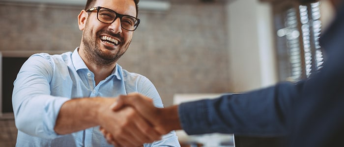 Man shaking hand and smiling